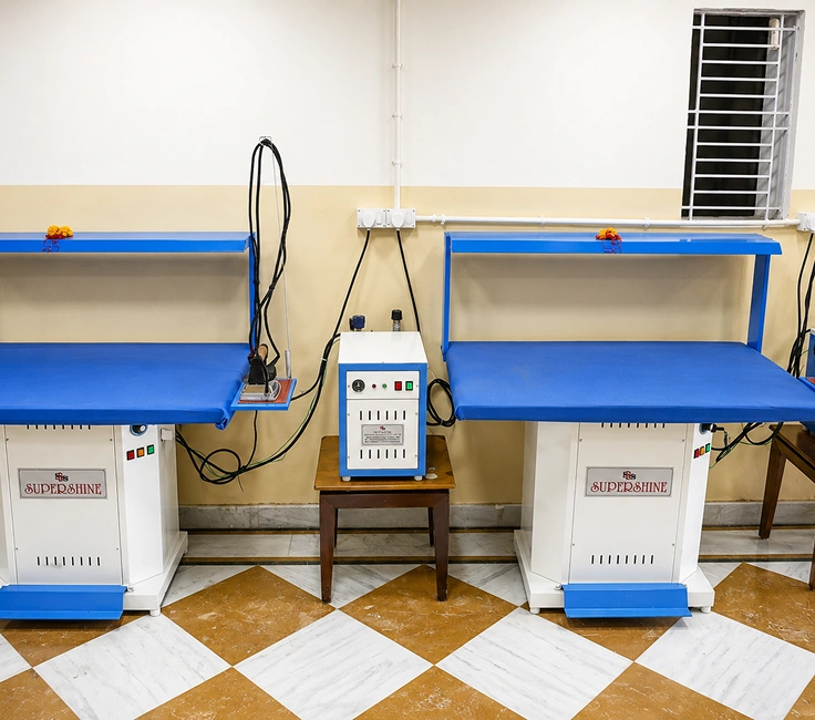 Supershine vacuum ironing tables with steam iron setup at Damodar Dham Nathdwara Rajasthan