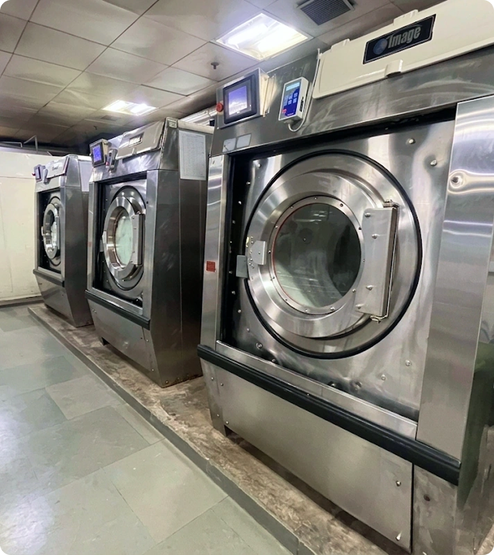 Row of Image Laundry Systems washer extractors installed at Holiday Inn Aerocity's in-house laundry facility, New Delhi