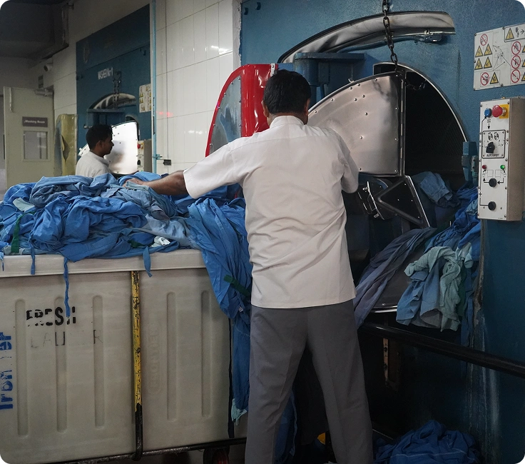 Medanta Hospital Gurugram In-House Laundry Facility Staff Sorting And Processing Hospital Scrubs And Patient Linen