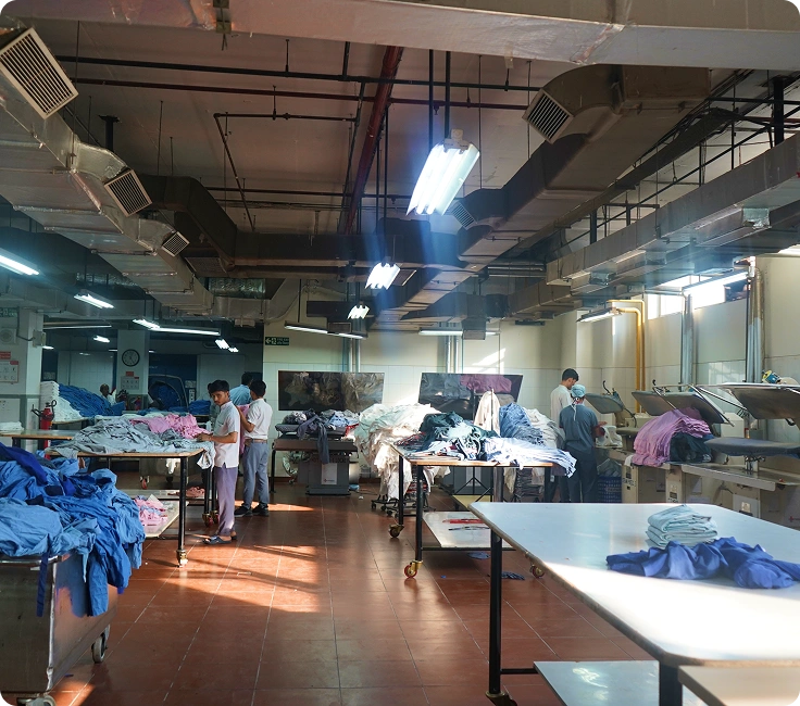 Medanta Hospital Gurugram Laundry Staff Loading Surgical Scrubs Into Industrial Washer Extractor For Processing