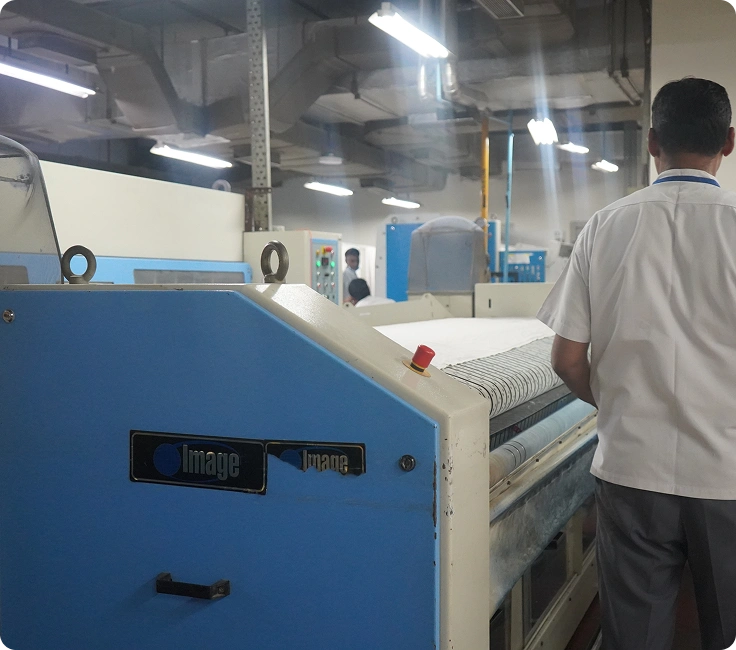 Medanta Hospital Gurugram Image Laundry Systems Flatwork Ironer Being Operated By Laundry Staff